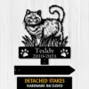 Black cat memorial metal yard stake with paw prints, text “Teddy 2010-2024,” on white wood background