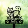 Black cat memorial garden stake in grass with paw prints and text Teddy 2010-2024