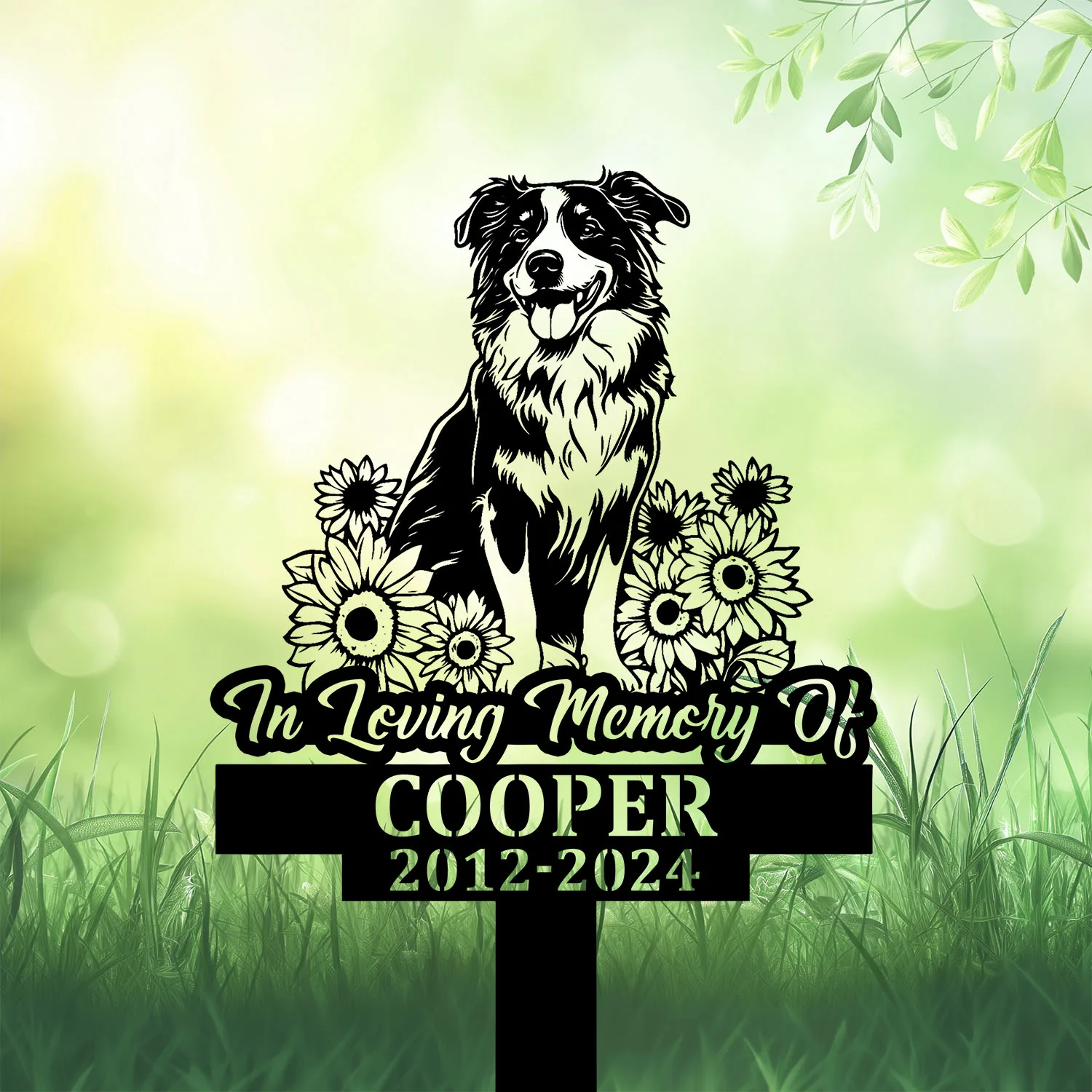 Black garden memorial stake with dog and flowers, reading In Loving Memory Of Cooper 2012-2024