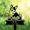 A memorial sign featuring a corgi surrounded by flowers, with the text 'In Loving Memory of Orion 2014-2024'.