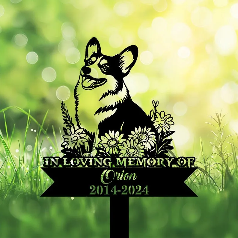 A memorial sign featuring a corgi surrounded by flowers, with the text 'In Loving Memory of Orion 2014-2024'.