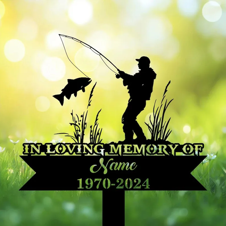 Fisherman memorial garden stake with fish silhouette, reading In Loving Memory of Name 1970-2024 in grass