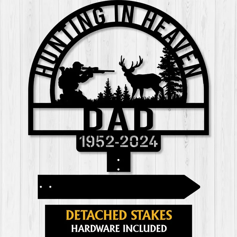 Black metal “Hunting in Heaven Dad 1952-2024” memorial yard stake with hunter, deer, and trees on white wood.