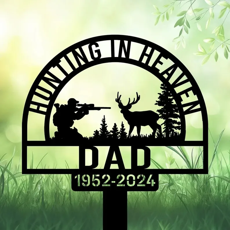 Black memorial garden stake reading “Hunting in Heaven Dad 1952-2024” with hunter, deer, and pine silhouettes