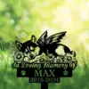 A memorial sign featuring a winged dog among flowers, with text 'In Loving Memory Of MAX 2016-2024'.