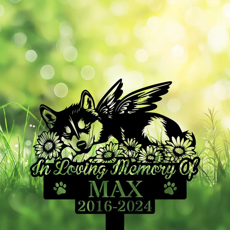 A memorial sign featuring a winged dog among flowers, with text 'In Loving Memory Of MAX 2016-2024'.