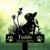 A black silhouette of a dog named Teddy with flowers and a butterfly on a green background.