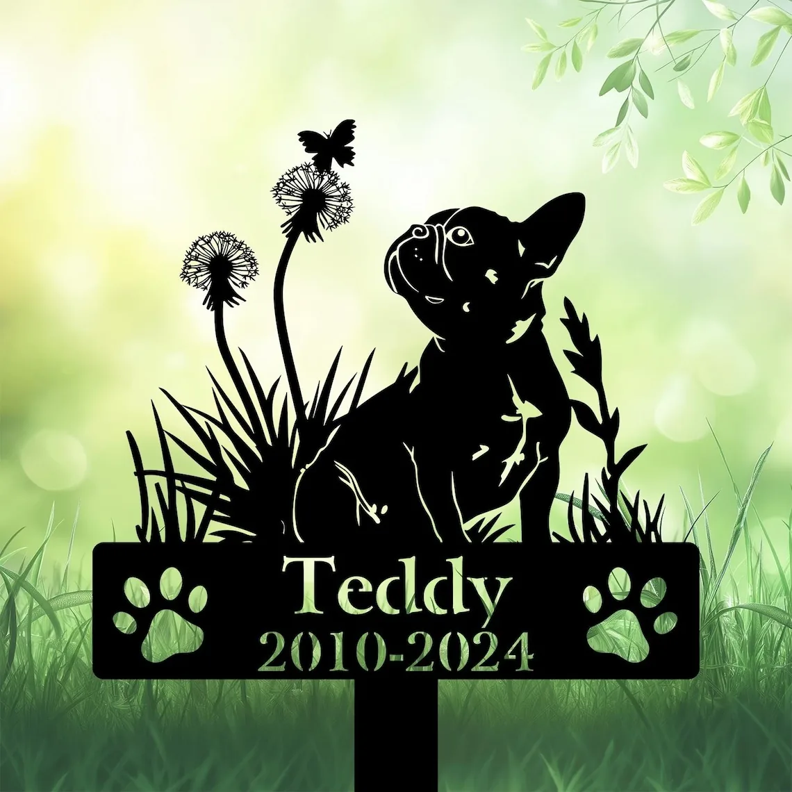 A black silhouette of a dog named Teddy with flowers and a butterfly on a green background.
