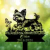 A memorial sign featuring a playful dog with a butterfly, reading 'In Loving Memory of Orion 2014-2024'.