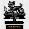 A memorial plaque featuring a playful dog silhouette, with text honoring 'Orion 2014-2024' and detached stakes included.