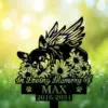 A memorial plaque featuring a sleeping dog surrounded by flowers, with the text 'In Loving Memory Of MAX 2016-2024'.