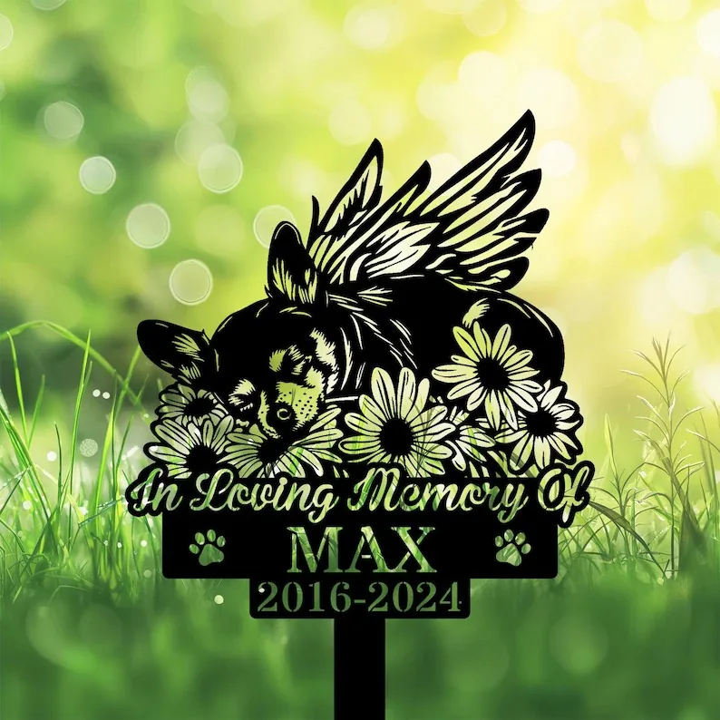 A memorial sign featuring a sleeping dog with wings, surrounded by flowers, with the text 'In Loving Memory Of MAX 2016-2024'.