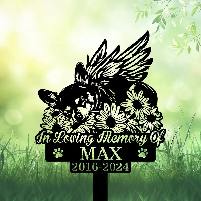 A decorative memorial sign featuring a sleeping dog with wings surrounded by flowers, reading 'In Loving Memory Of MAX 2016-2024'.