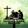 A memorial featuring a cross, a motorcyclist silhouette, and the text 'CUSTOM NAME 1960-2023' on a green background.