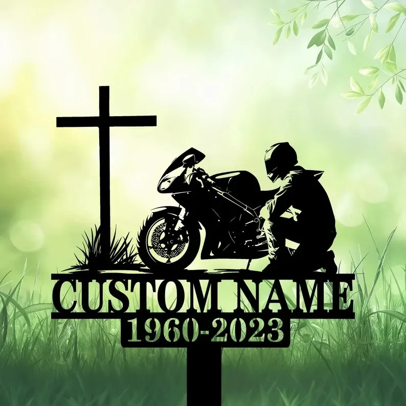 A memorial featuring a cross, a motorcyclist silhouette, and the text 'CUSTOM NAME 1960-2023' on a green background.