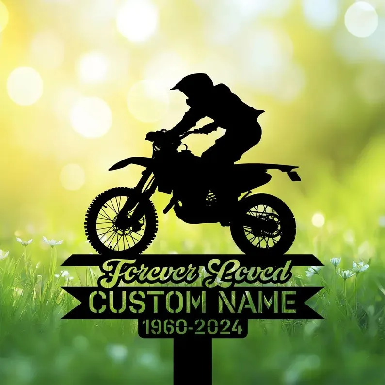 Dirt bike rider memorial garden stake reading “Forever Loved Custom Name 1960-2024” in grass