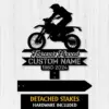 Black motocross memorial yard sign with rider silhouette, “Forever Loved Custom Name 1960-2024,” on white wood wall
