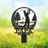 Black metal yard sign silhouette of a golfer swinging with trees and a flag, text 'PAPA' and dates '1944 - 2025' set in grassy outdoor scene