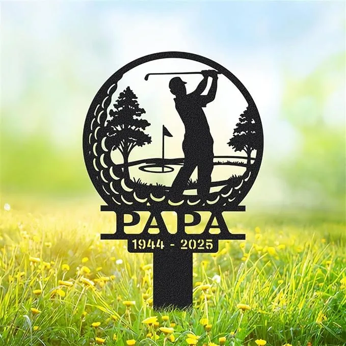 Black metal yard sign silhouette of a golfer swinging with trees and a flag, text 'PAPA' and dates '1944 - 2025' set in grassy outdoor scene