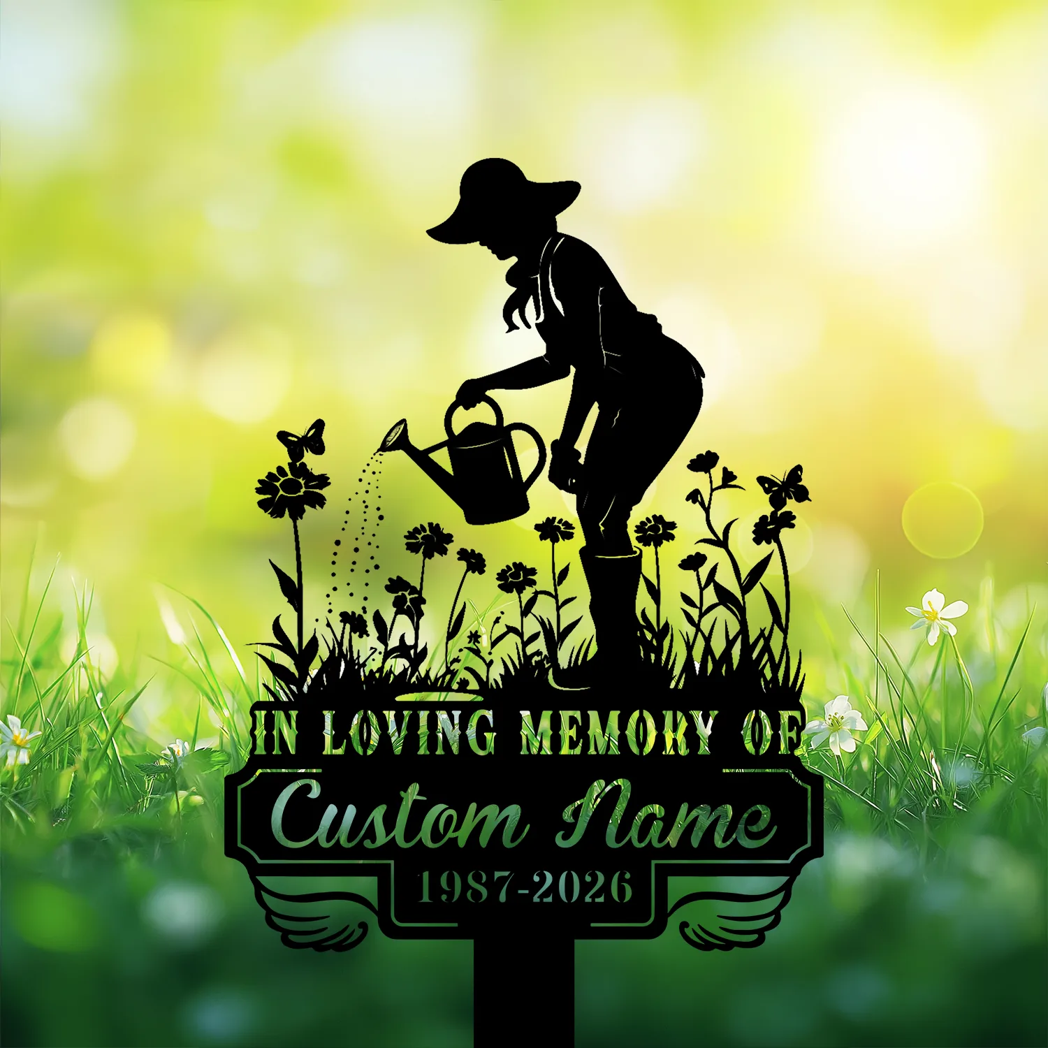 Black silhouette memorial sign of a woman watering flowers with butterflies, 'IN LOVING MEMORY OF' and placeholder 'Custom Name 1987-2026' on a sunny green bokeh background