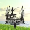 Silhouette memorial yard sign showing a fisherman on a dock with reeds and cattails, text reading "In Loving Memory of CUSTOM NAME 1960 - 2023" against a lakeside sky background