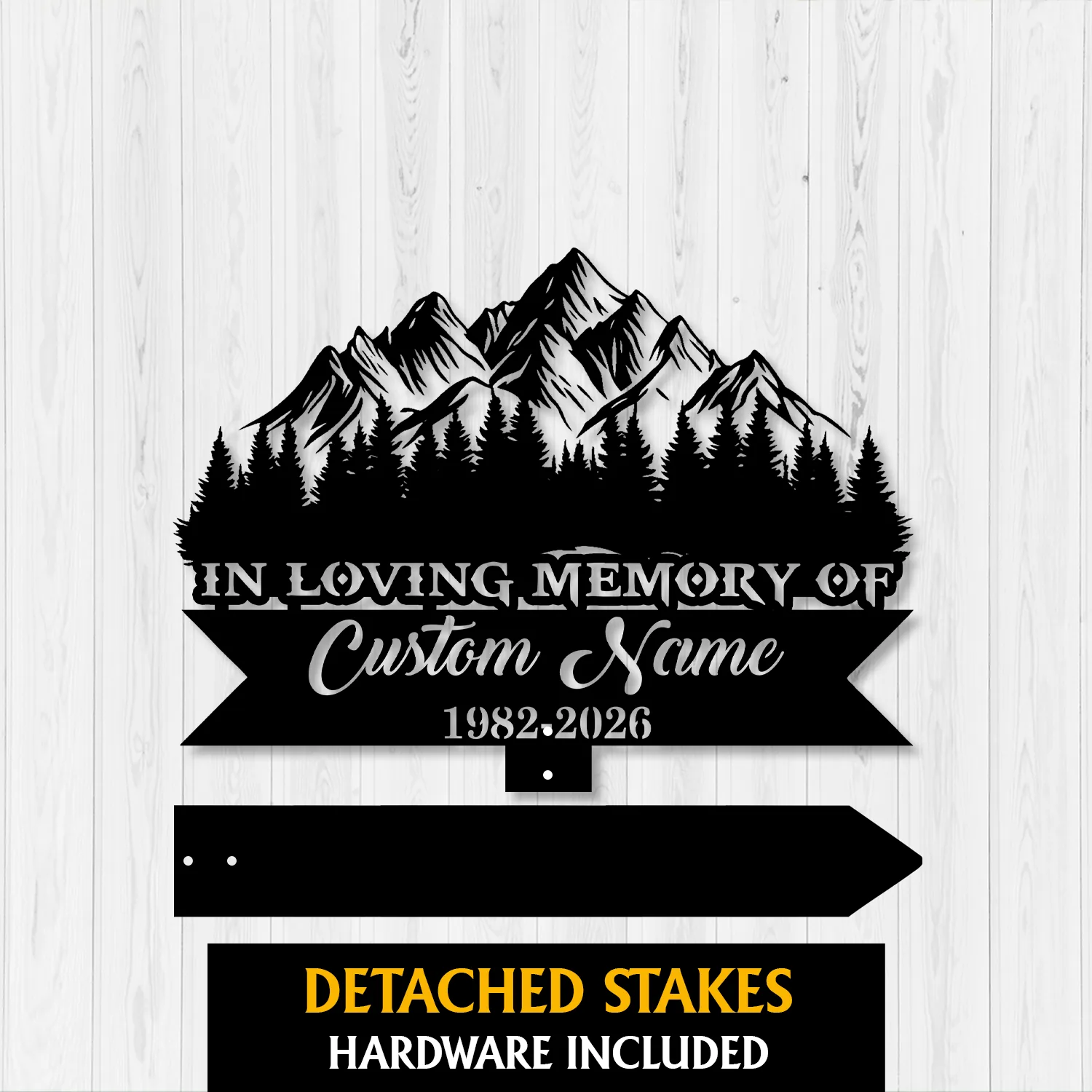 11a Black metal memorial sign silhouette of mountains and pine trees on white wood background reading "In Loving Memory of" with placeholder "Custom Name" and dates 1982-2026, detached stakes shown