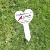 122 Heart-shaped white memorial yard sign on grass reading "Cardinals appear when Angels are near" with a red cardinal illustration and name "Ryan A. Lambert 2001-2023"