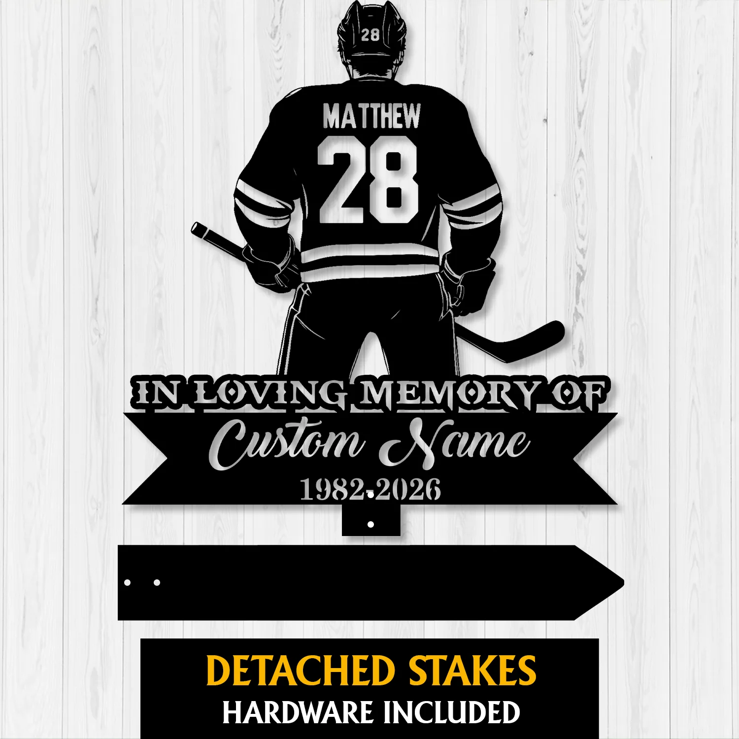 14a Black silhouette hockey player from behind wearing jersey 'MATTHEW' and number 28 above ribbon reading 'In Loving Memory of Custom Name 1982-2026' on a light wood background