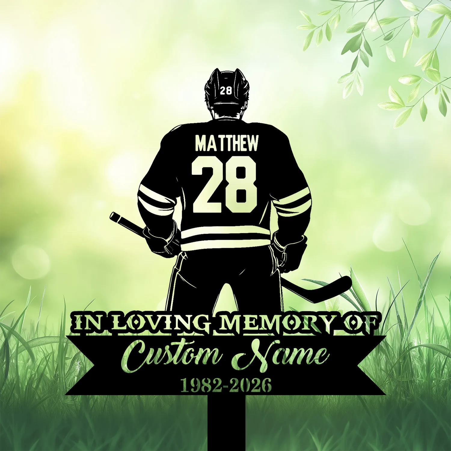 14b Silhouette of a hockey player wearing jersey name MATTHEW and number 28, standing over a memorial sign reading "In Loving Memory" and placeholder "Custom Name 1982-2026" on a green leafy background