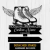 Black silhouette memorial sign showing winged ice skates above text “In Loving Memory Of” and a customizable name with dates on a light wood background