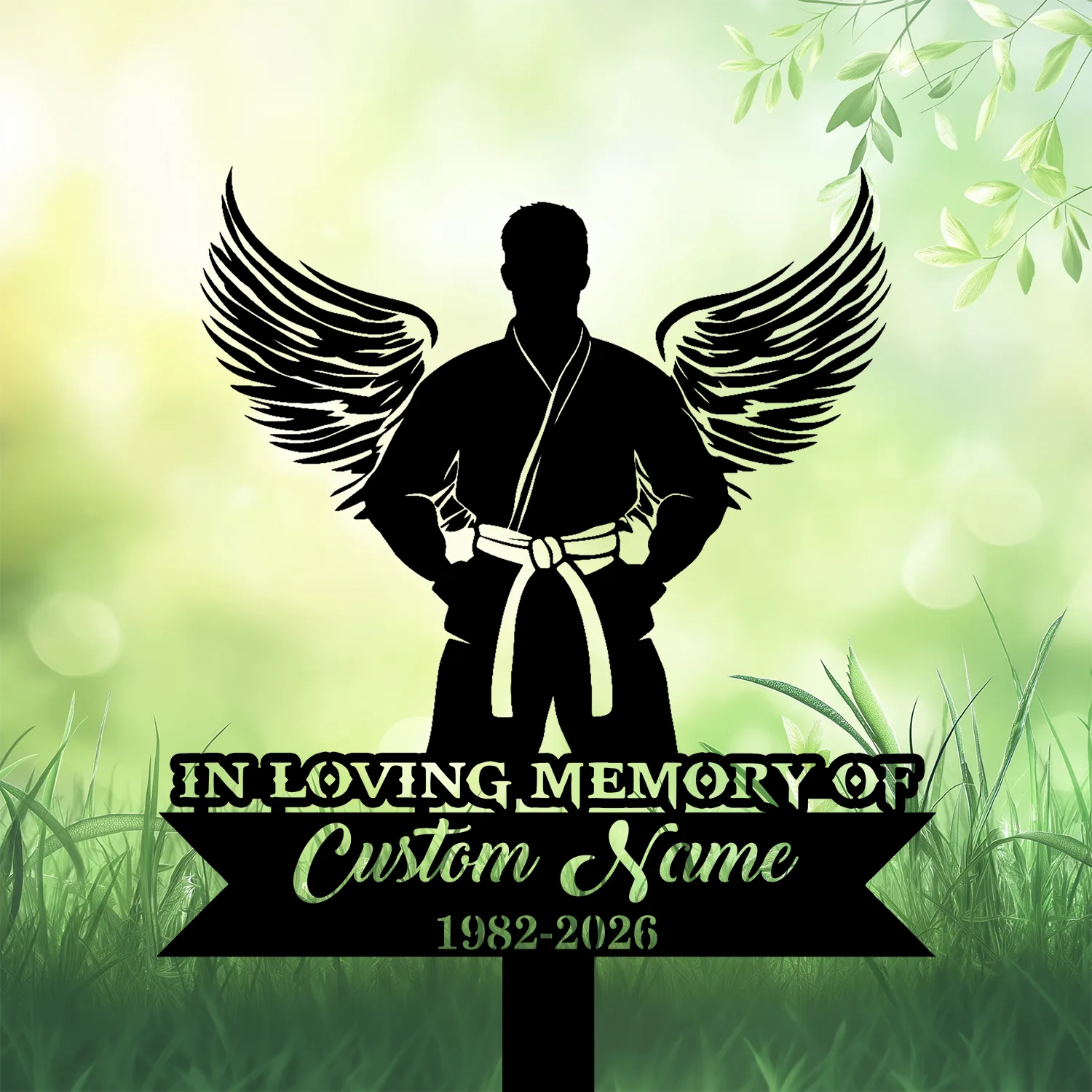 Silhouette of a martial artist with wings and a belt standing over a black memorial plaque reading “In Loving Memory, Custom Name, 1982-2026” on a green nature background