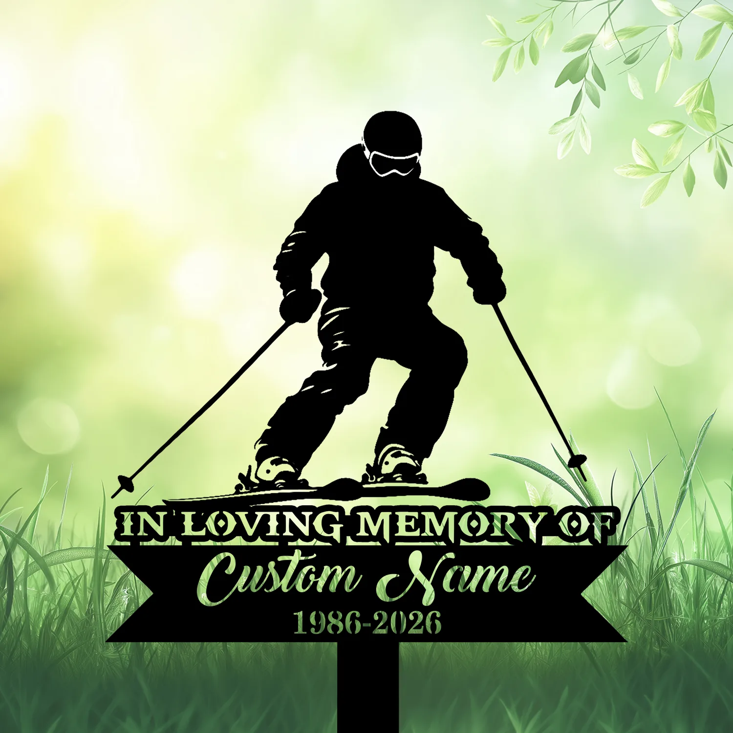 Black silhouette of a skier on a memorial lawn sign reading "In Loving Memory" with placeholder "Custom Name" and dates 1986-2026 against a soft green leafy background