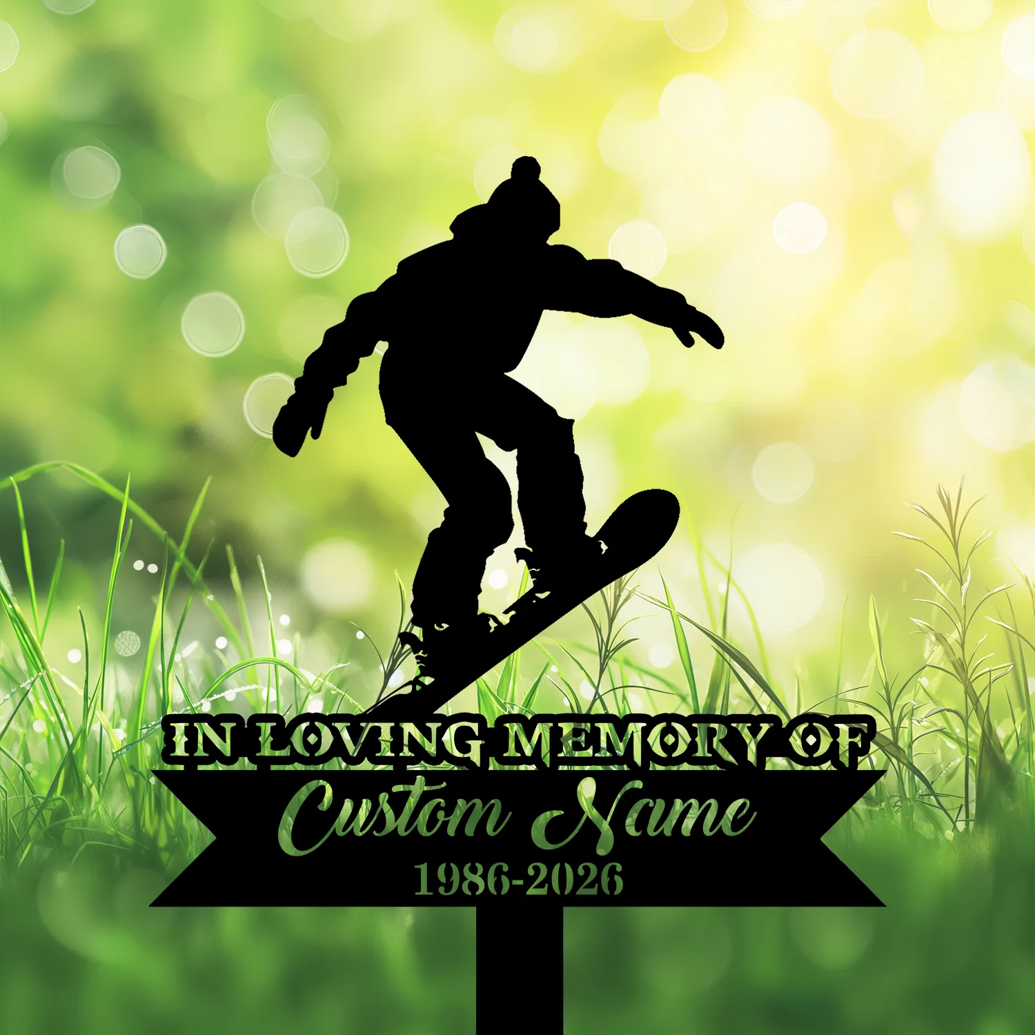 Silhouette of a snowboarder jumping above a memorial sign reading "IN LOVING MEMORY OF Custom Name 1986-2026" against a sunlit green bokeh and grassy background