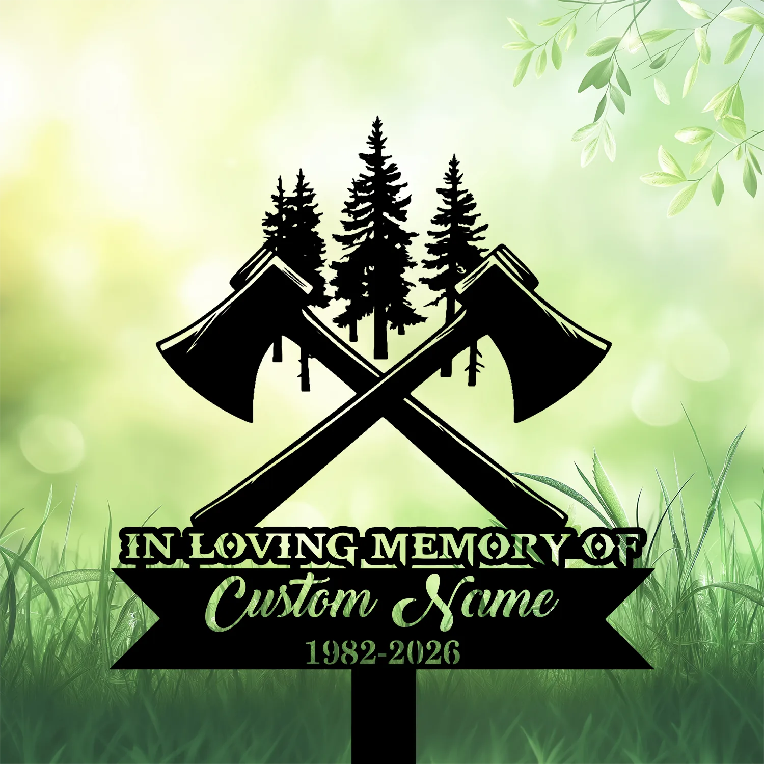 Black memorial sign with crossed axes and pine trees silhouette, text reading "In Loving Memory of Custom Name 1982-2026" against a soft green grassy background