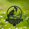 Black metal memorial garden stake with a bird and flowers, engraved text reading "In Loving Memory Of" and placeholder "CUSTOM NAME 1950 - 2024", set in grassy lawn