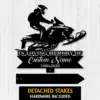 Black metal memorial sign silhouette of a person riding a snowmobile above text reading "In Loving Memory of Custom Name 1986-2026" on a white wood background