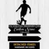 Black metal memorial sign silhouette of a soccer player with ball above a ribbon reading "In Loving Memory of" and placeholder "Custom Name 1986-2026" on a light wood background