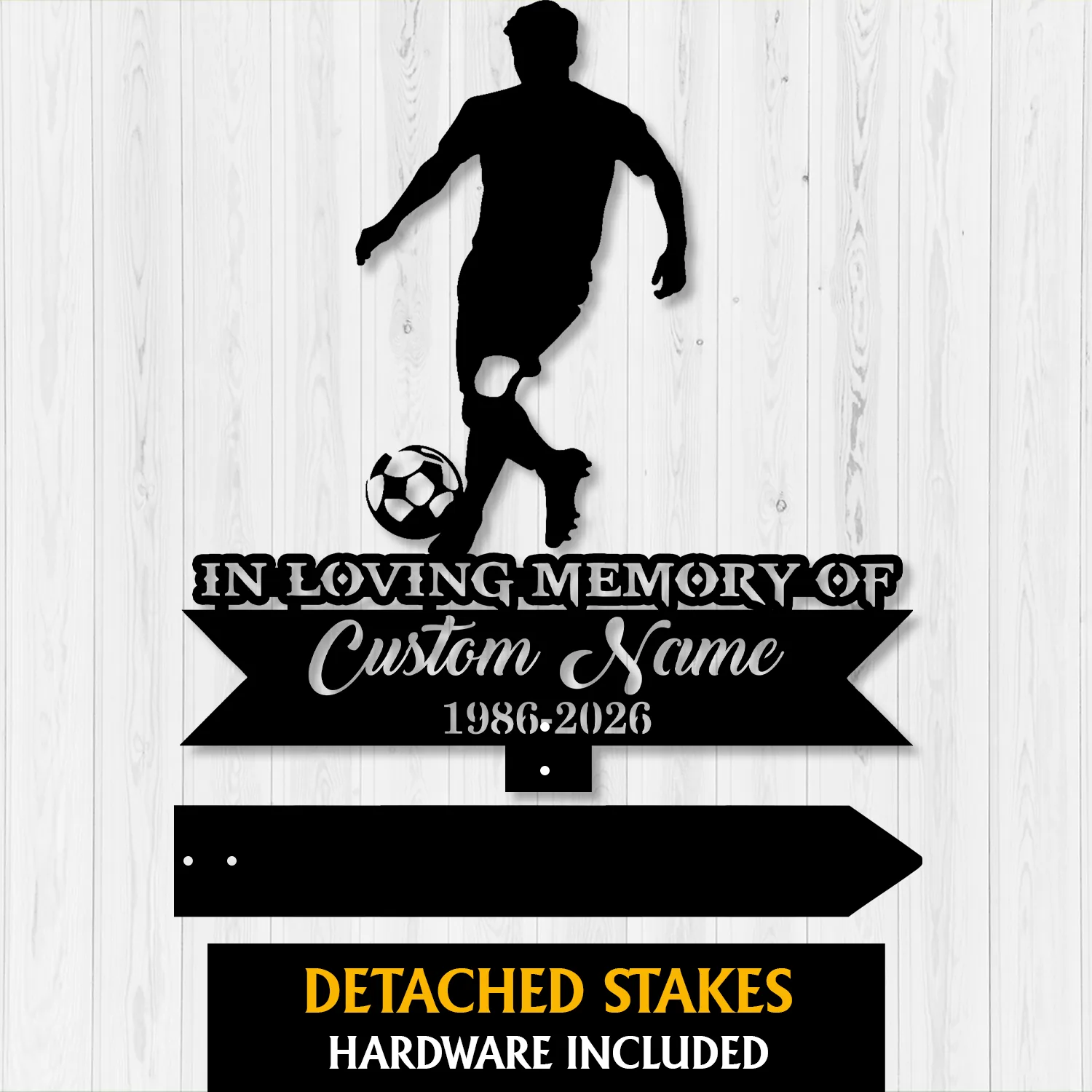 Black metal memorial sign silhouette of a soccer player with ball above a ribbon reading "In Loving Memory of" and placeholder "Custom Name 1986-2026" on a light wood background