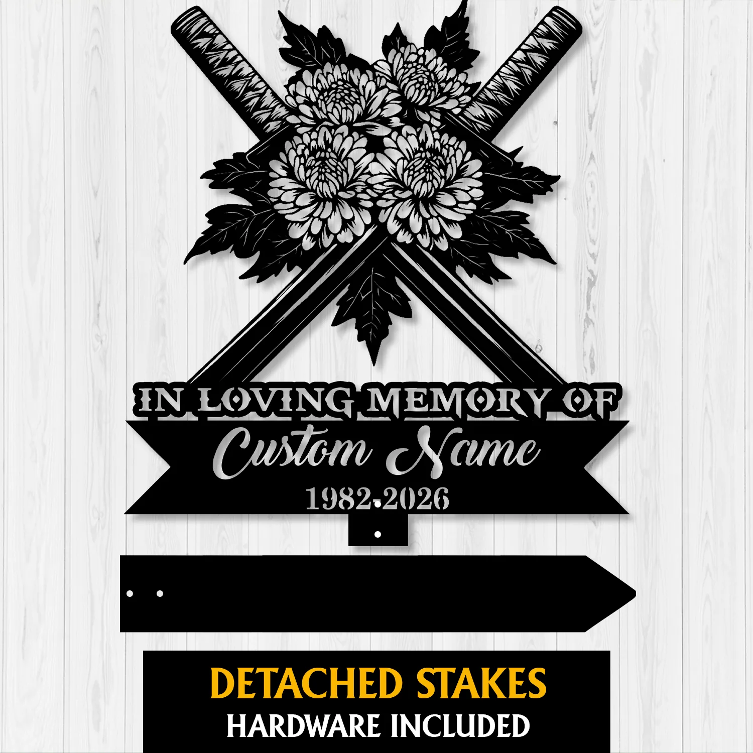 Black metal memorial sign with crossed swords and chrysanthemum flowers, text reading "IN LOVING MEMORY OF" and placeholder "Custom Name" with years 1982-2026 on a light wood background
