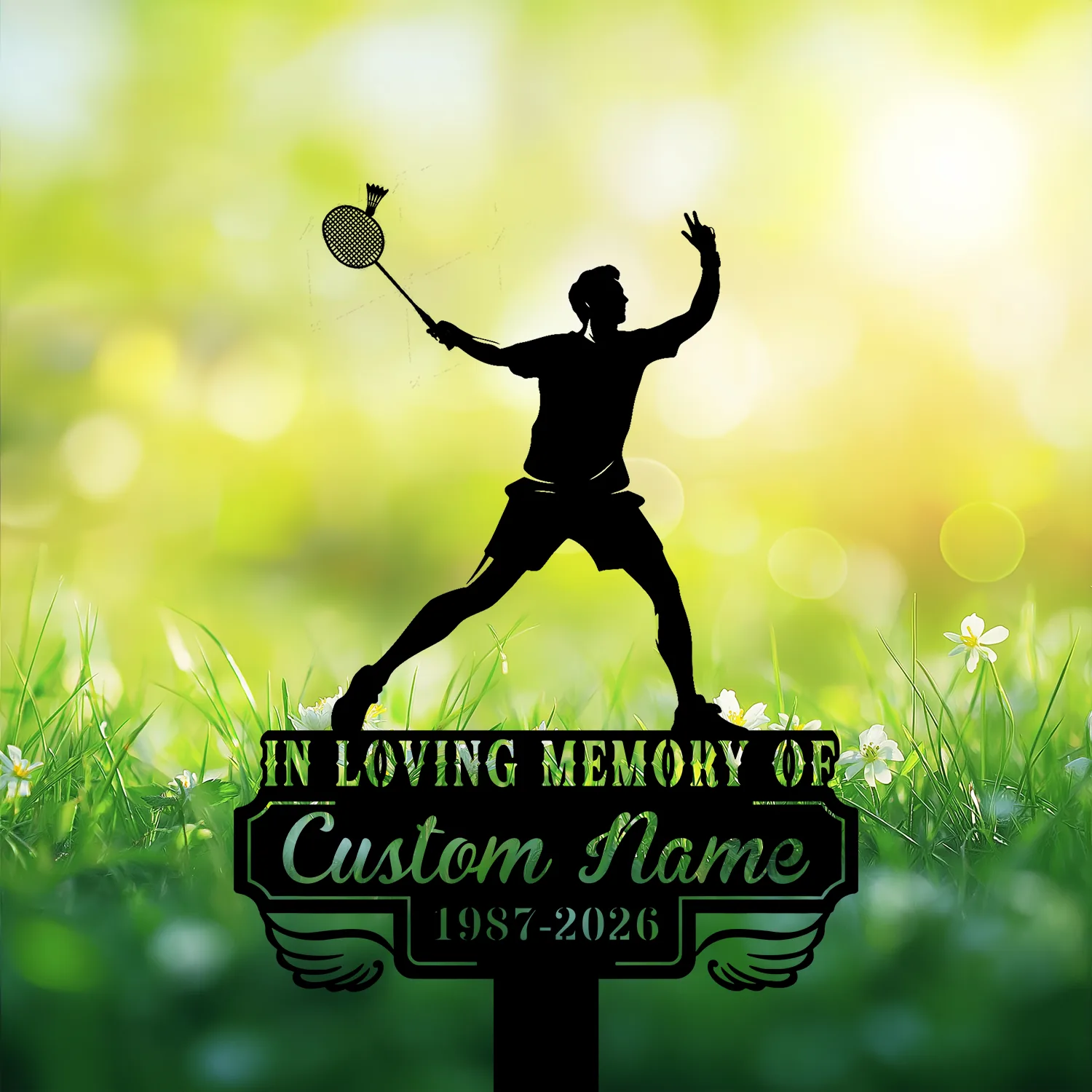 Black silhouette of a badminton player on a memorial sign reading "In Loving Memory of Custom Name 1987-2026" against a sunlit grassy background
