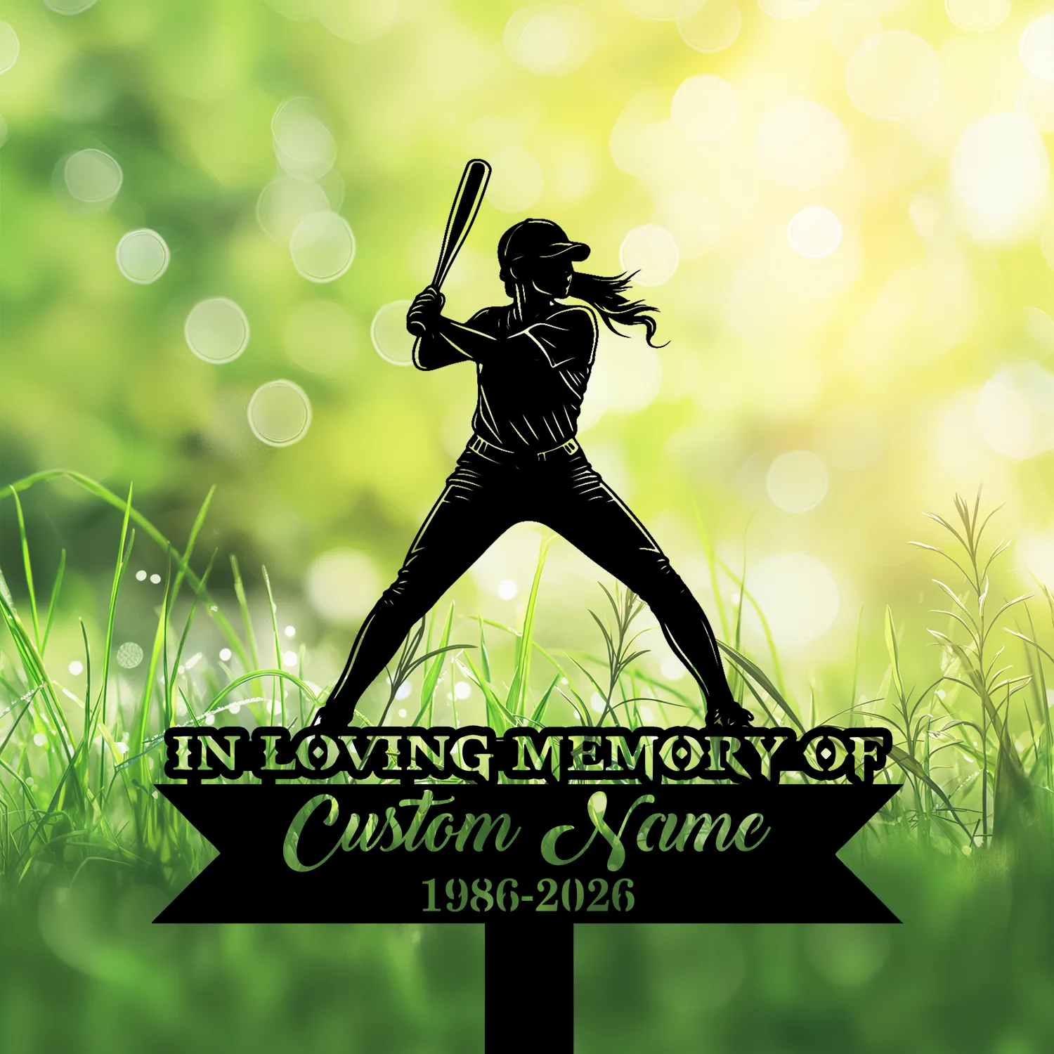 Silhouette of a female softball player at bat above a memorial sign reading "IN LOVING MEMORY OF Custom Name 1986-2026" against a sunlit green grass background