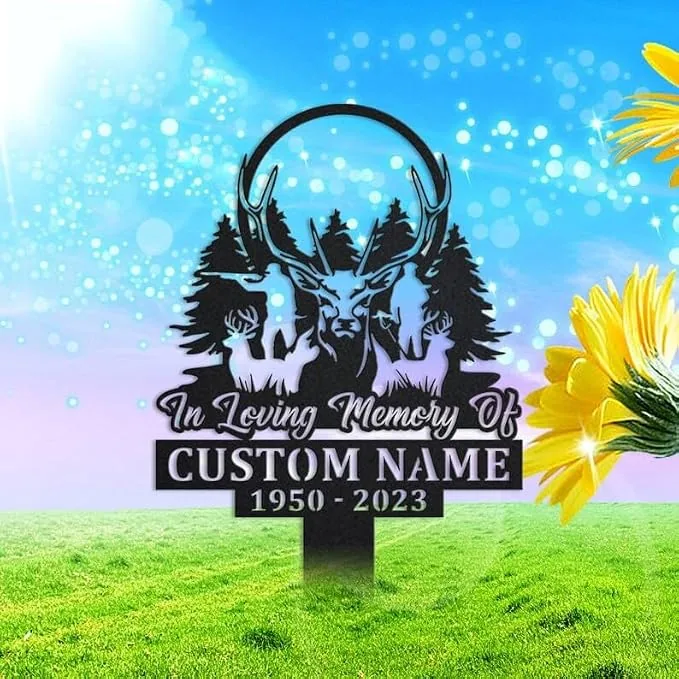 202 Memorial yard sign with deer silhouettes, pine trees and antlers reading "In Loving Memory Of" and placeholder "CUSTOM NAME 1950-2023" on a grassy lawn with sunflowers and blue sky.