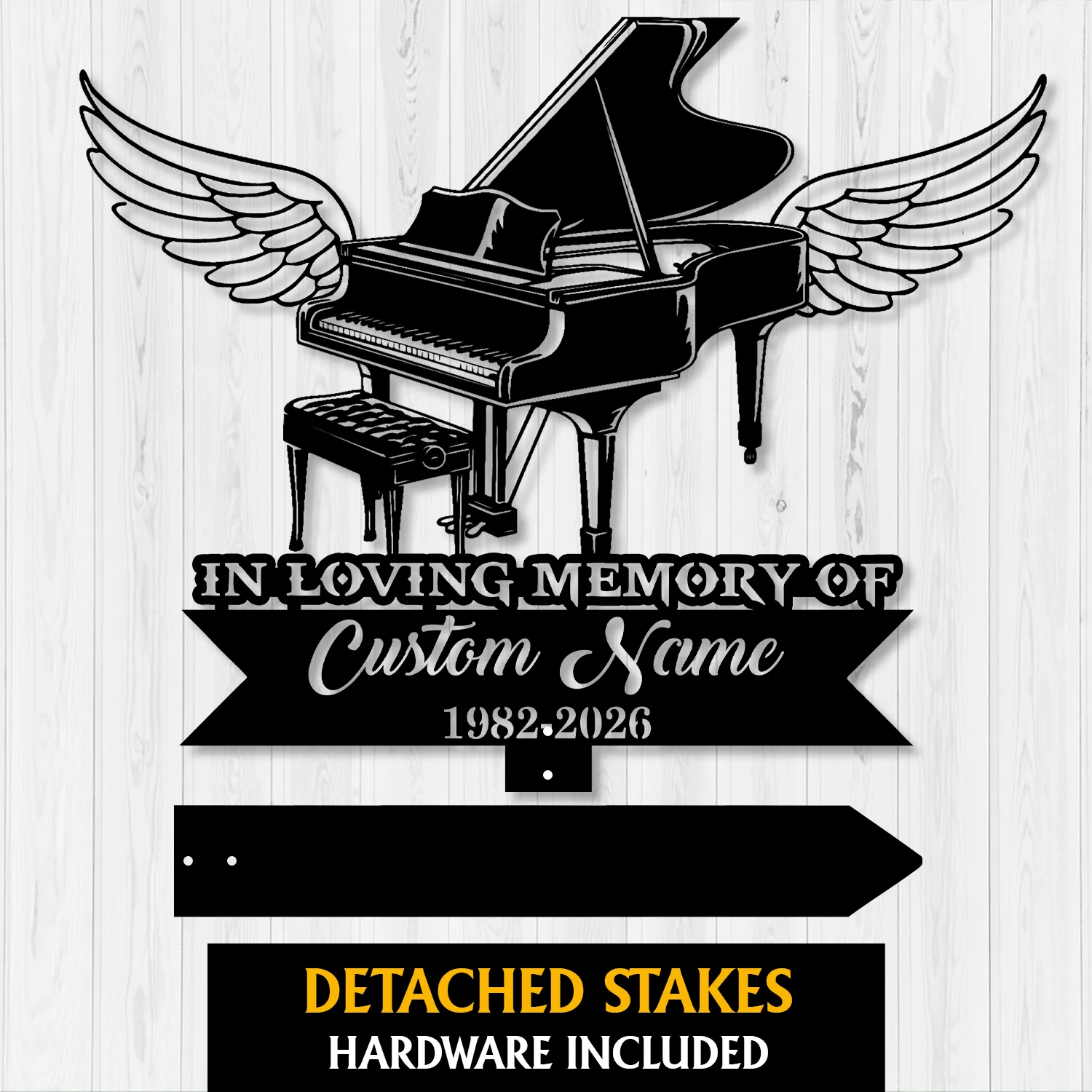 Black silhouette memorial sign of a grand piano with angel wings above a banner reading “In Loving Memory of” and placeholder “Custom Name” with years 1982–2026 on a light wood background