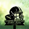 Black silhouette of a football helmet and ball above a banner reading “In Loving Memory of Custom Name 1982-2026” set against a soft green grassy background with leaves