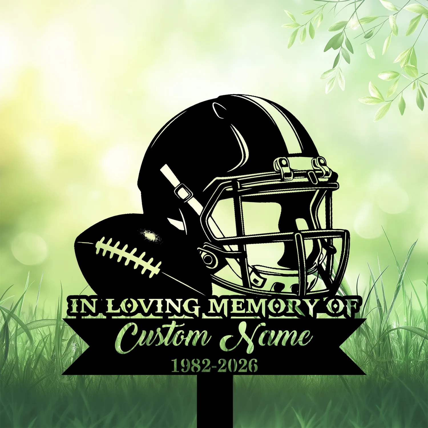 Black silhouette of a football helmet and ball above a banner reading “In Loving Memory of Custom Name 1982-2026” set against a soft green grassy background with leaves