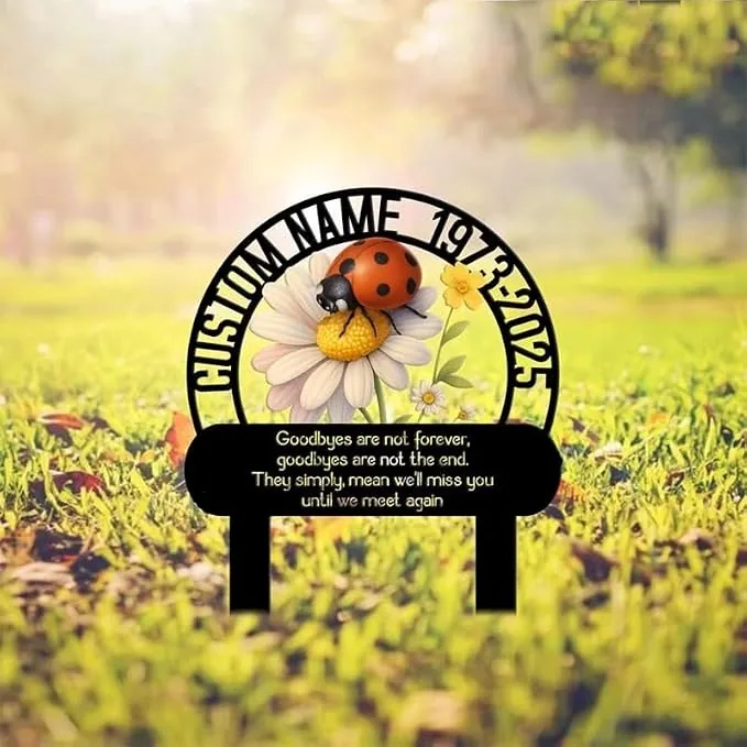Outdoor memorial garden stake with a daisy and ladybug illustration, circular frame reading 'CUSTOM NAME 1973-2025' and a sentimental goodbye message plaque