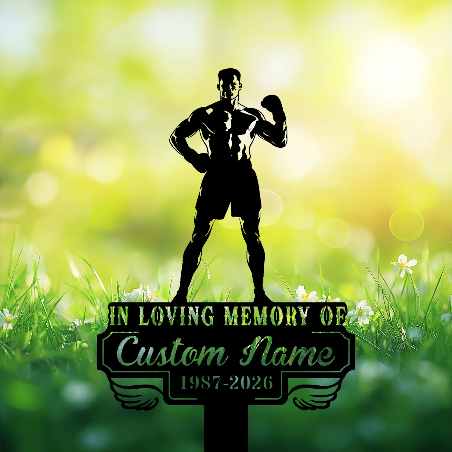 Silhouette memorial sign of a muscular boxer standing over a plaque reading "In Loving Memory of Custom Name 1987-2026" set against sunlit grass and white flowers
