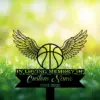 4-3 Black memorial sign with a winged basketball and text placeholder "In Loving Memory of Custom Name 1982-2026" set against a sunlit grassy background with small white flowers