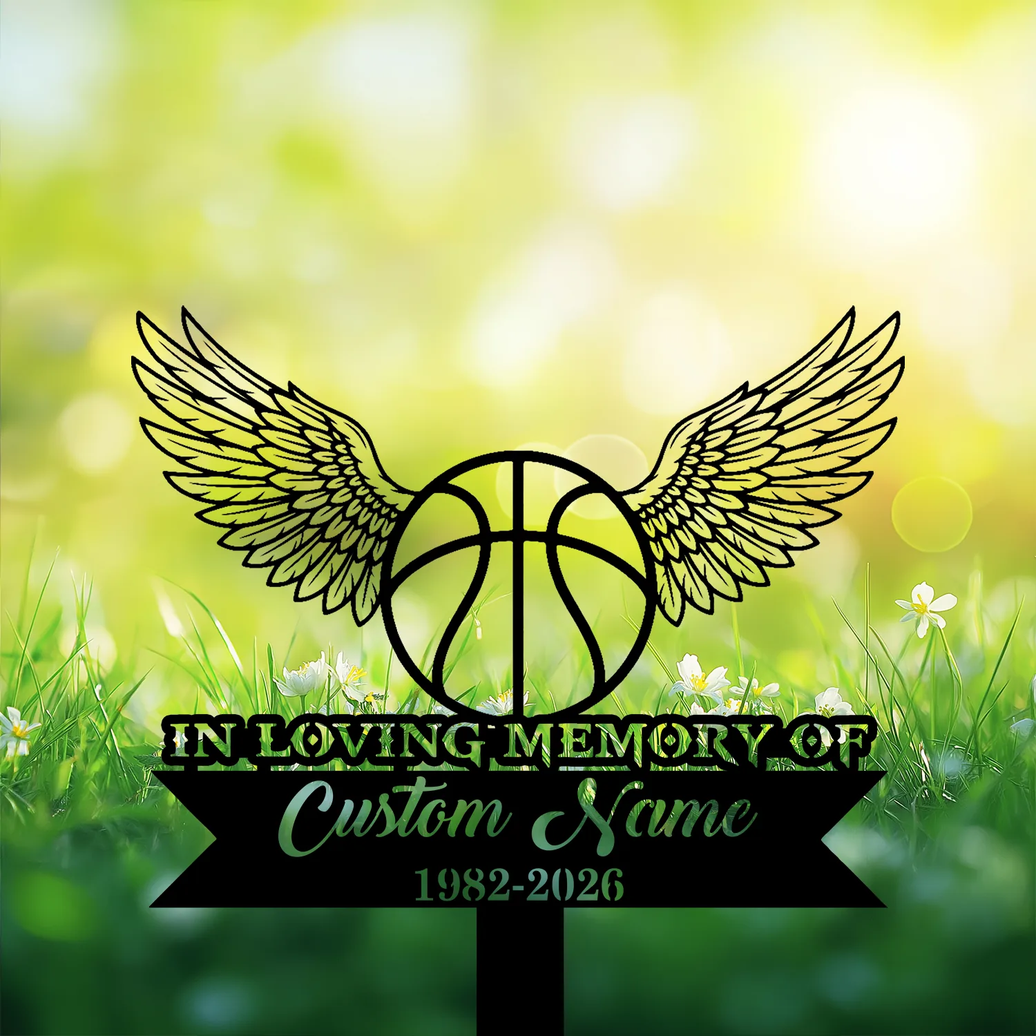 4-3 Black memorial sign with a winged basketball and text placeholder "In Loving Memory of Custom Name 1982-2026" set against a sunlit grassy background with small white flowers