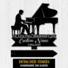 4a-1 Black silhouette sign of a pianist at a grand piano reading "In Loving Memory of" with "Custom Name" and years 1986-2026 on a light wood background